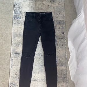 Black jeans with holes in the knees